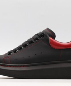 ALEXANDER MCQUEEN black oversized sneakers with red heel